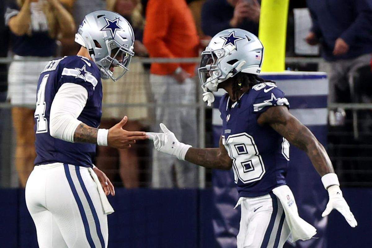 ARLINGTON, TEXAS - DECEMBER 30: CeeDee Lamb #88 of the Dallas Cowboys celebrates with Dak Prescott #4 after scoring a 92 yard touchdown against the Detroit Lions during the first quarter in the game at AT&T Stadium on December 30, 2023 in Arlington, Texas. (Photo by Richard Rodriguez/Getty Images)