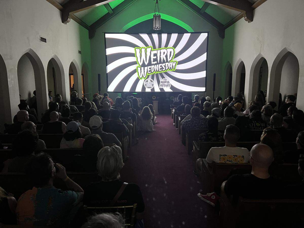 A crowd at Weird Wednesday watches a movie in Southside Preservation Hall’s Rose Chapel.
