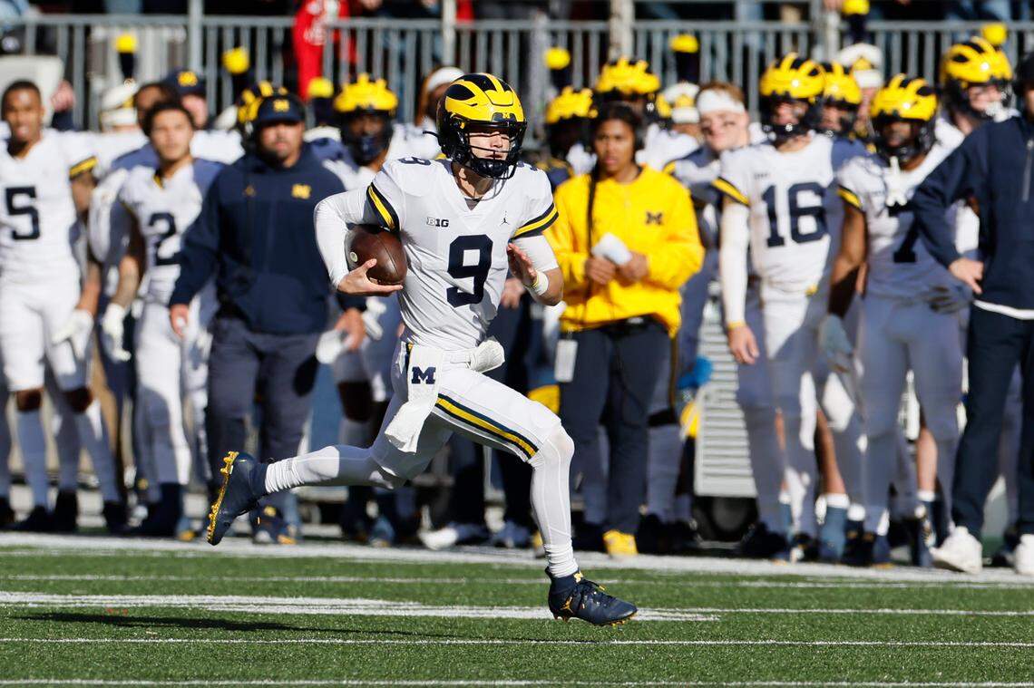 Michigan quarterback J.J. McCarthy runs past the Ohio State defense during their game on Nov. 26, 2022, in Columbus, Ohio