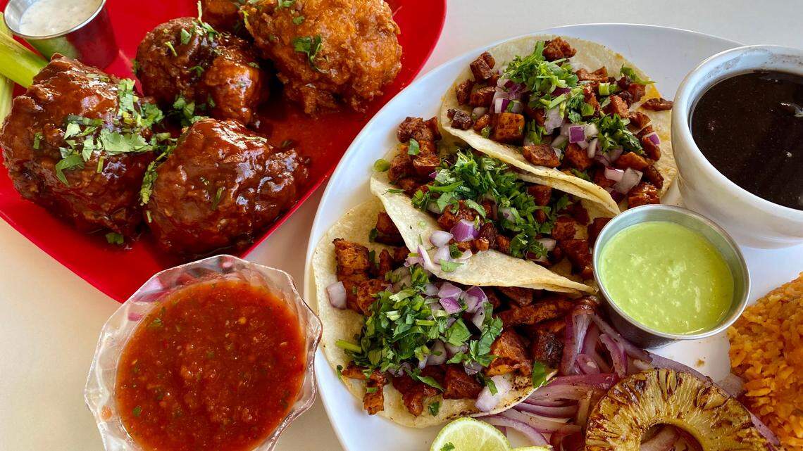 BBQ and Buffalo cauliflower balls, left, with a tacos “pastor” platter at Belenty’s in Fort Worth.