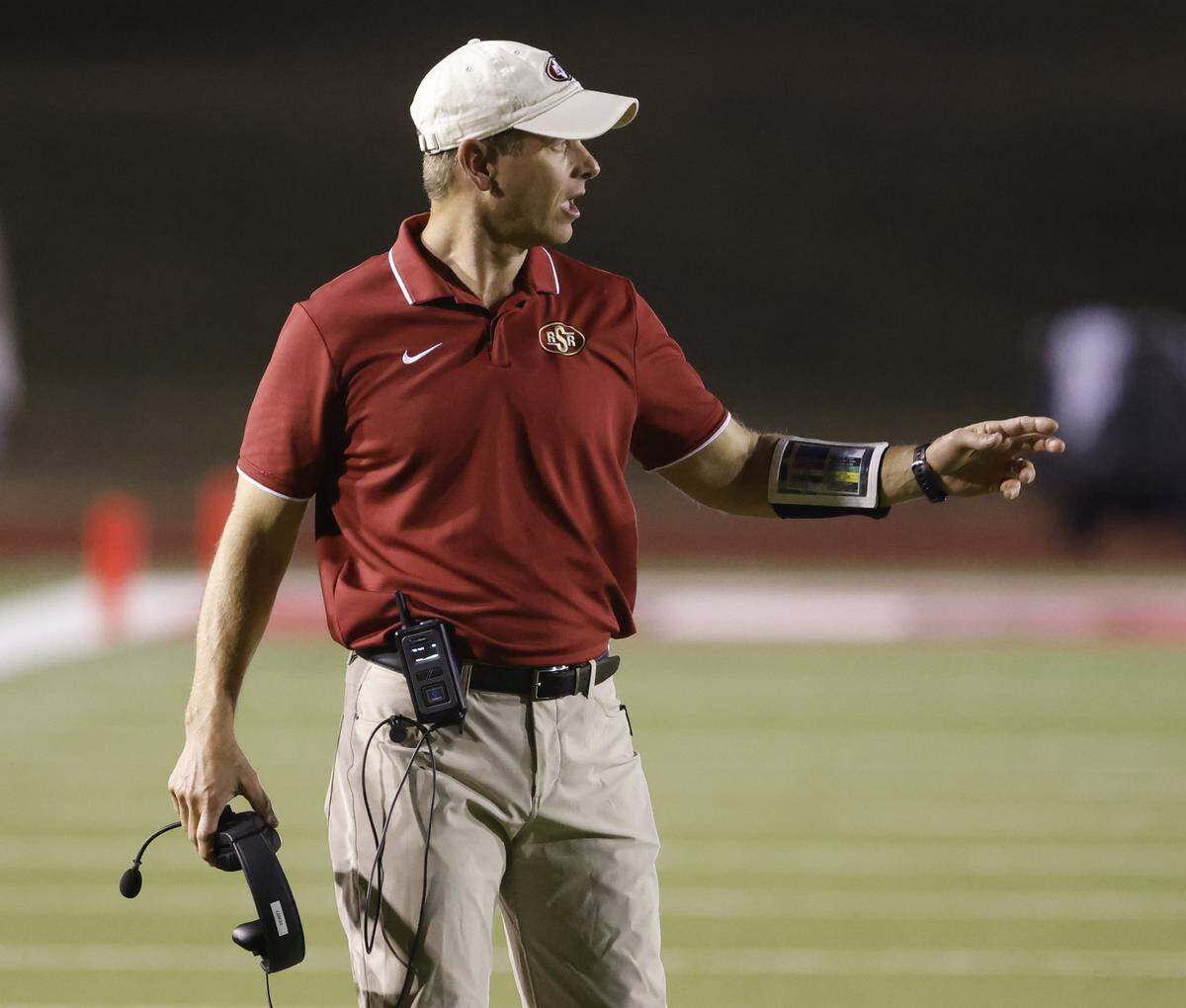 Saginaw head coach Mike Dewitt sends in instructions during the first half of a UIL football game between Saginaw and Paschal at Farrington Field in Fort Worth, Texas, Thursday, October, 16, 2025.