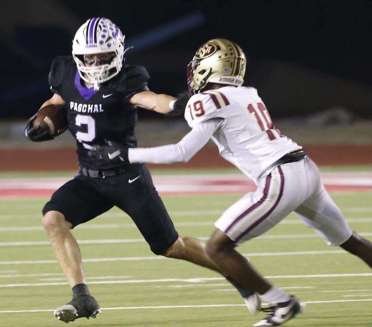 Paschal running back Truman Shelton (2) avoids the tackle of Saginaw safety Luke Roseberry (19) during the first half of a UIL football game between Saginaw and Paschal at Farrington Field in Fort Worth, Texas, Thursday, October, 16, 2025.