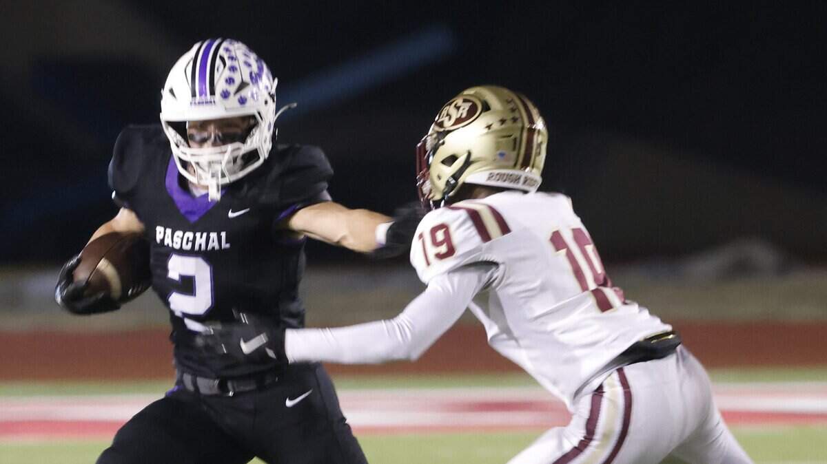 Paschal running back Truman Shelton (2) avoids the tackle of Saginaw safety Luke Roseberry (19) during the first half of a UIL football game between Saginaw and Paschal at Farrington Field in Fort Worth, Texas, Thursday, October, 16, 2025.