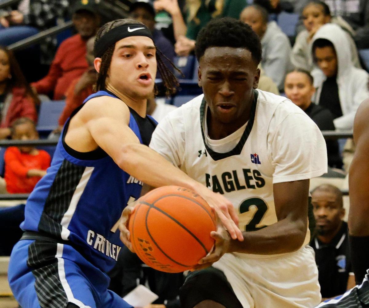 North Crowley guard Abram Hicks (1) reaches in on Lakeridge guard Abisayo Gbakinro (12) during a UIL boys basketball game at Lake Ridge High School in Mansfield, Texas, Tuesday, Jan. 24, 2025.