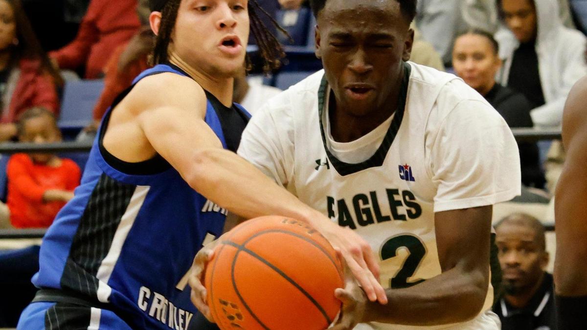 North Crowley guard Abram Hicks (1) reaches in on Lakeridge guard Abisayo Gbakinro (12) during a UIL boys basketball game at Lake Ridge High School in Mansfield, Texas, Tuesday, Jan. 24, 2025.