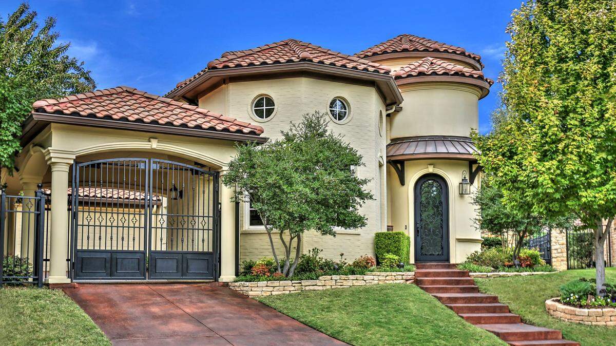 The home at 6624 Augusta Road is on a cul-de-sac and boasts a wrought-iron gated driveway.