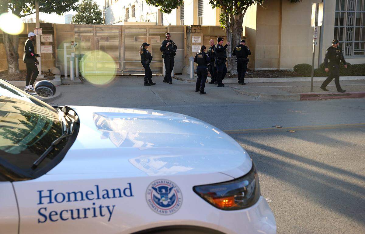 Law enforcement agents stand outside the federal courthouse in downtown Fort Worth on Monday, Feb. 23, 2026. A second attempt of the trial of nine defendants indicted in connection to the nonfatal shooting of a police officer outside a North Texas ICE detention center last year began Monday.