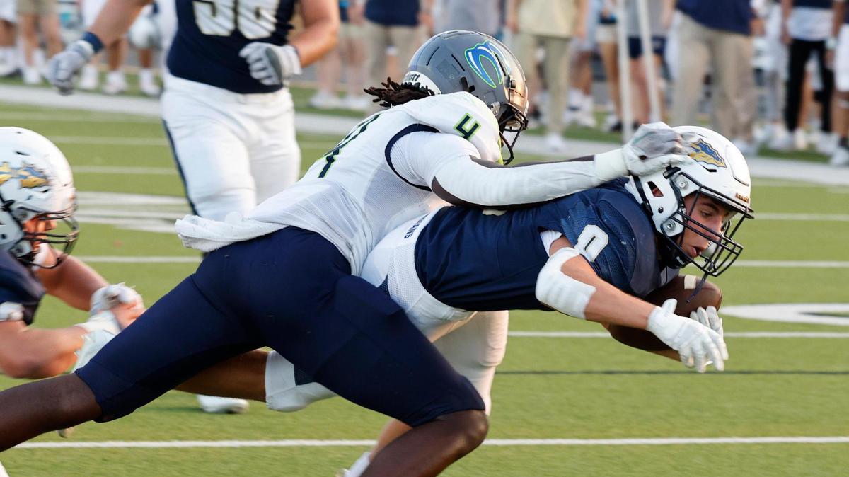 Keller running back Kyle Owens (0) carries Eaton safety Fred Moore (4) into the end zone in the first half of a UIL high school football game at Keller ISD Stadium in Keller, Texas, Friday, Sept. 15, 2023. Keller led Eaton 31-14 at the half.