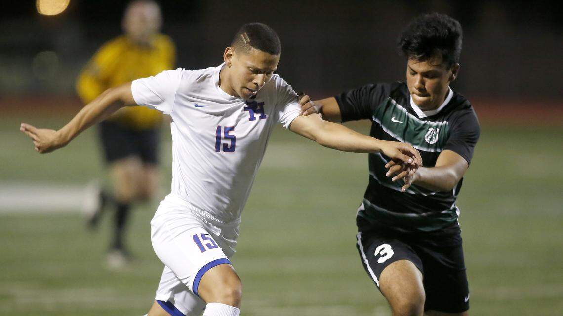 Sam Houston Texans striker Jose Ortiz (15) battles with Arlington High’s Jason Garcis during first-half action at Wilemon Field in Arlington, Texas , March 23, 2018.