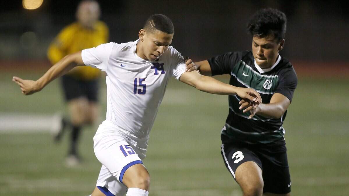 Sam Houston Texans striker Jose Ortiz (15) battles with Arlington High's Jason Garcis during first-half action at Wilemon Field in Arlington, Texas , March 23, 2018.