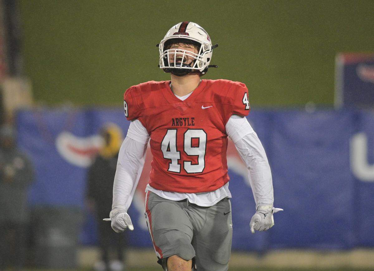 Argyle defensive linemen Reno Hermann (49) celebrates a sack during a Class 5A Division II state semifinal on Friday, Dec. 13, 2024 at Gerald J. Ford Stadium in University Park, Texas.