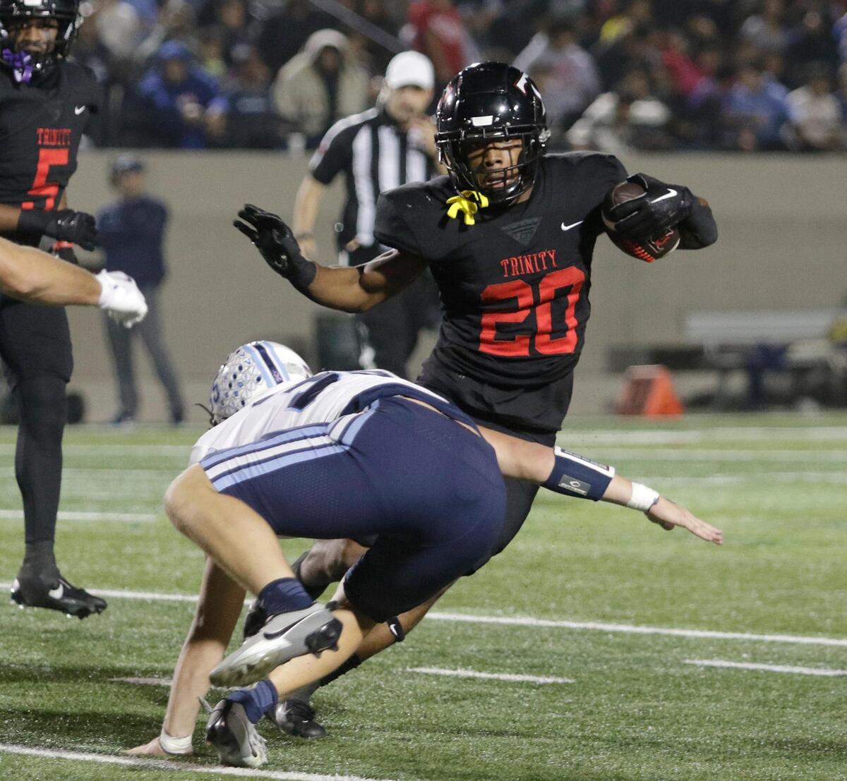 Trinity’s Josh Bell cuts back to evade a tackle during a UIL football game at Pennington Field on Thursday, November 7, 2024.