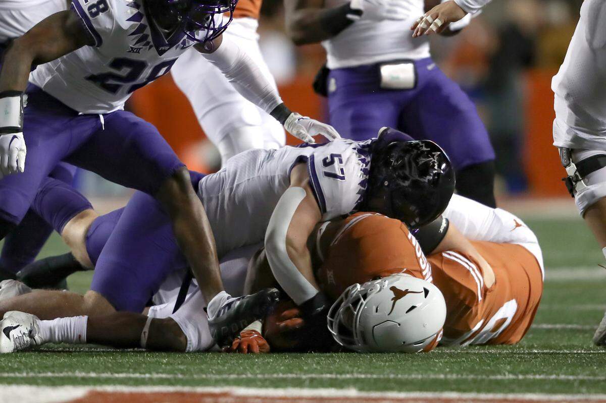 TCU linebacker Johnny Hodges tackles UT running back Roschon Johnson during their game at the DKR Texas Memorial Stadium in Austin on Saturday, Nov. 12, 2022.