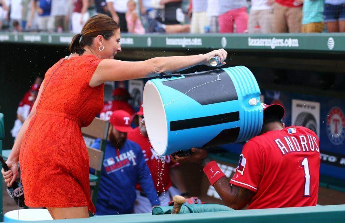 Fox Sports Southwest reporter Emily Jones attacks Texas Rangers shortstop Elvis Andrus (1) with silly string after being doused with sports drink after the Rangers beat the Red Sox 6-2 at Globe Life Park in Arlington, Sunday, June 26, 2016.