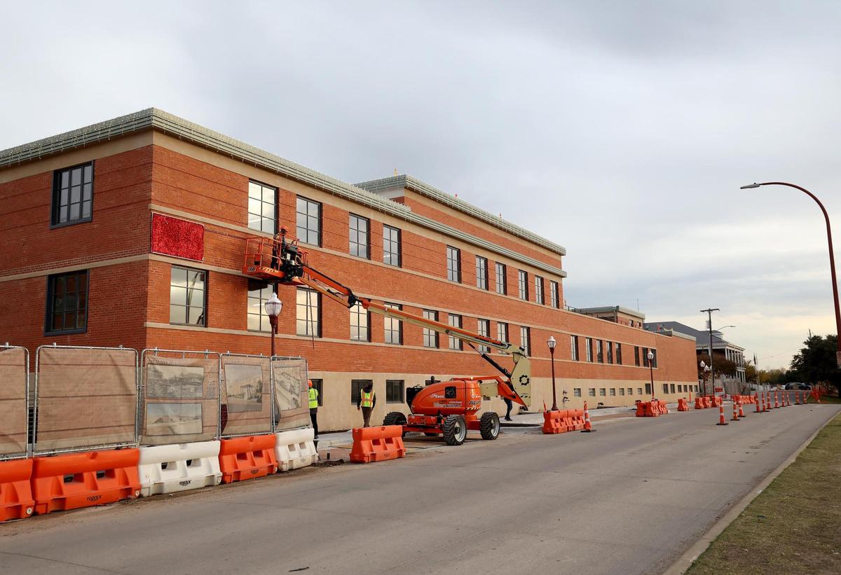 Decorations being hung on the historic Armour building in the Fort Worth Stockyards on Friday, Dec. 6, 2024.