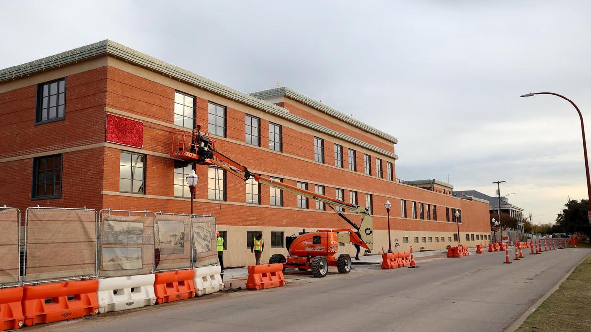 Decorations being hung on the historic Armour building in the Fort Worth Stockyards on Friday, Dec. 6, 2024.