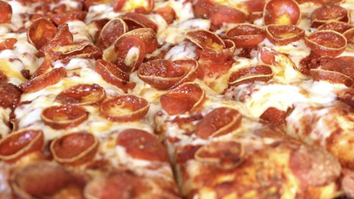 A crisp and curly pepperoni pizza.