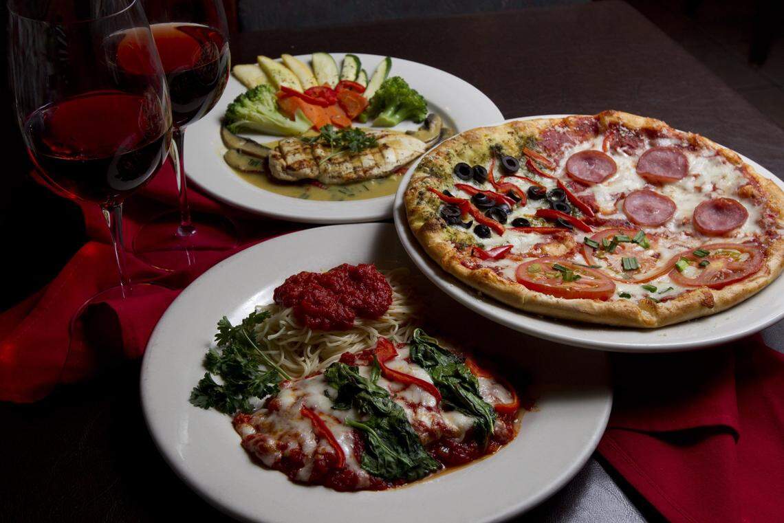 Eggplant parmigiana, chicken terasine and a special trio pizza at Cafe Bella in this file photo.