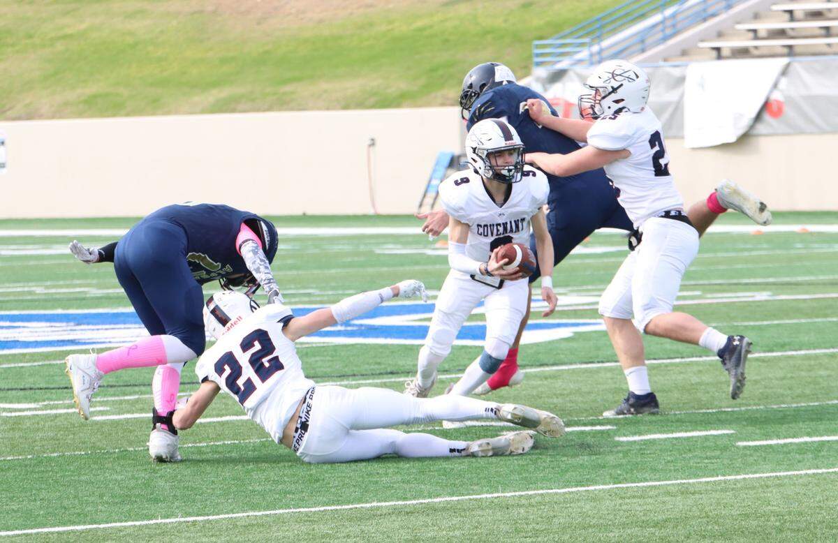 Fort Worth Covenant Classical quarterback Noah Keyes (9) scrambles as Luke Evans (25) and Jonathan Wade (22) provide protection against Huntsville Alpha Omega in the TAPPS Six-Man Division II Championship game on Thursday, Dec. 5, 2024 at Waco ISD Stadium in Waco, Texas.