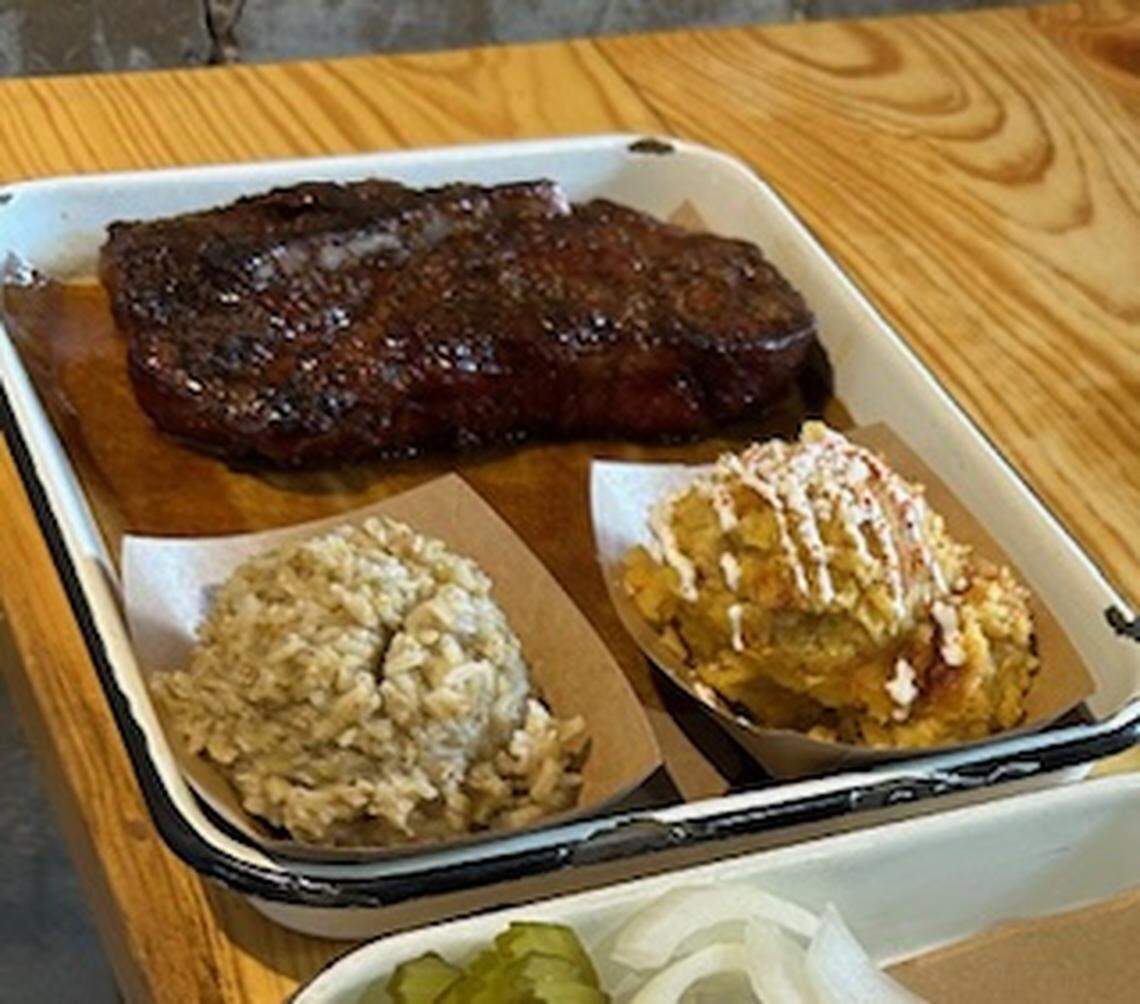 Bone-in pork steak with rice and street corn pudding at Burnt Bean Company in Seguin. 