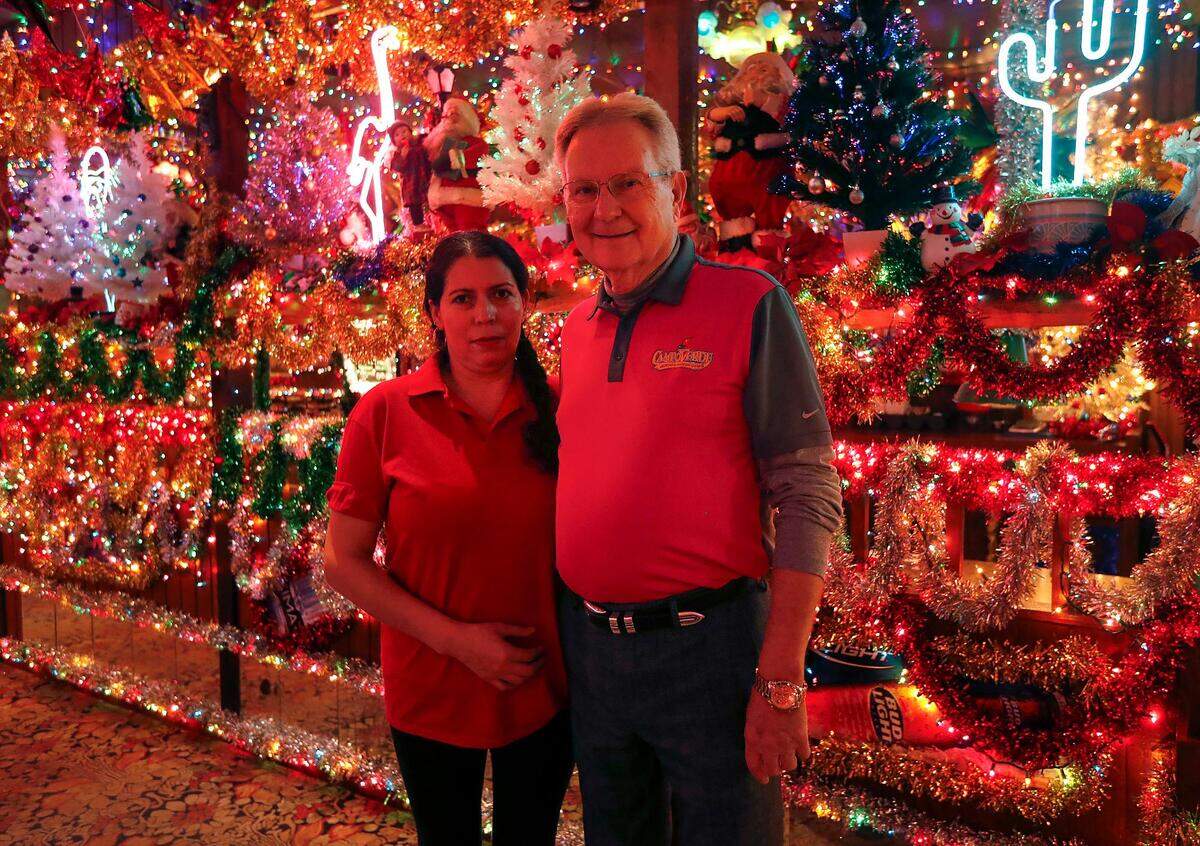 James Williams, owner of Campo Verde, stands with Gloria Guerrero, one of the two employees in charge of decorating the restaurant for the holidays. Williams says the decorating process takes around two months, starting in the beginning of October.