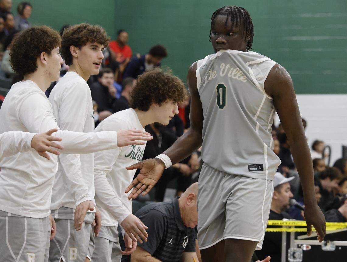 Team mates welcome Birdville forward Gabriel Zachariah (0) back to the bench in a game against Denton Ryan in the second half of a UIL basketball game at Birdville High School in North Richland Hills, Texas, Tuesday Feb. 17, 2026.