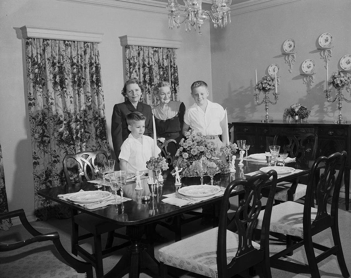 Nov. 1, 1952: Society series on Thanksgiving table settings. Formal Dinner: Fruit and flowers, combined with crystal, fine china and linen, sets the table for the Penner family dinner at 1406 Thomas PIace. From left, Mrs. Ted Penner, Mrs. J.H. Penner, and grandsons Danny, right, and Henry.