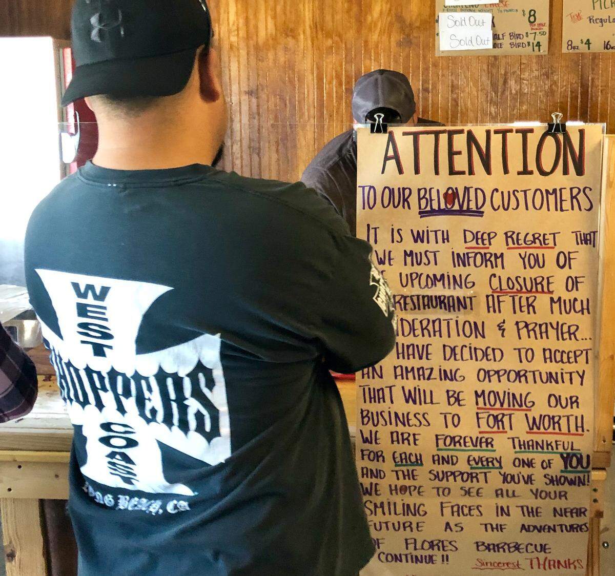 A sign at Flores Barbecue announces its move to Fort Worth.