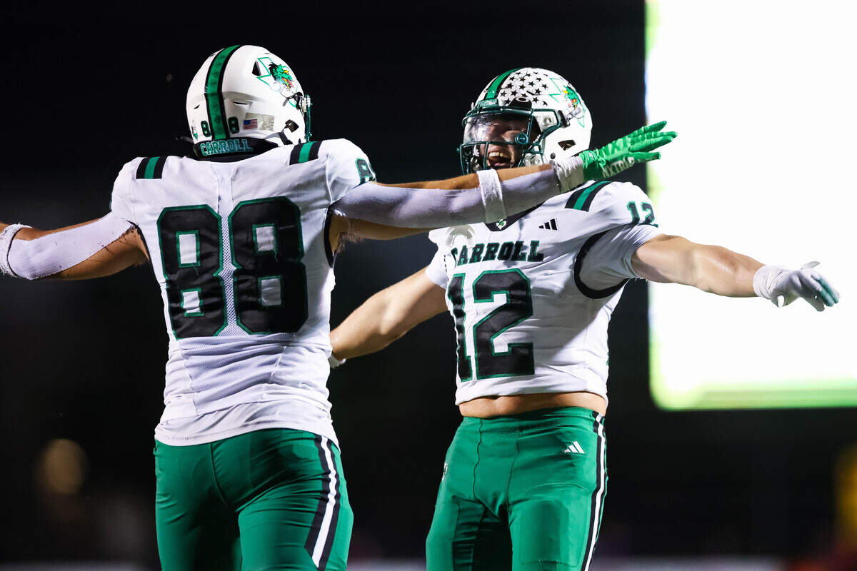 Southlake Carroll linebacker Marcus Brouse (12) celebrates with defensive lineman Crawford Taylor after a tackle for loss against Keller Timber Creek on Sept. 25 at Keller ISD Stadium.