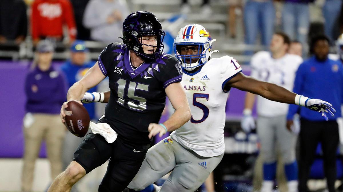 TCU quarterback Max Duggan (15) attempts to outrun Kansas safety O.J. Burroughs (5) in the second half of Saturday’s game against Kansas. Duggan showed his toughness by playing through a broken bone in his foot and leading the Horned Frogs to a 31-28 victory.