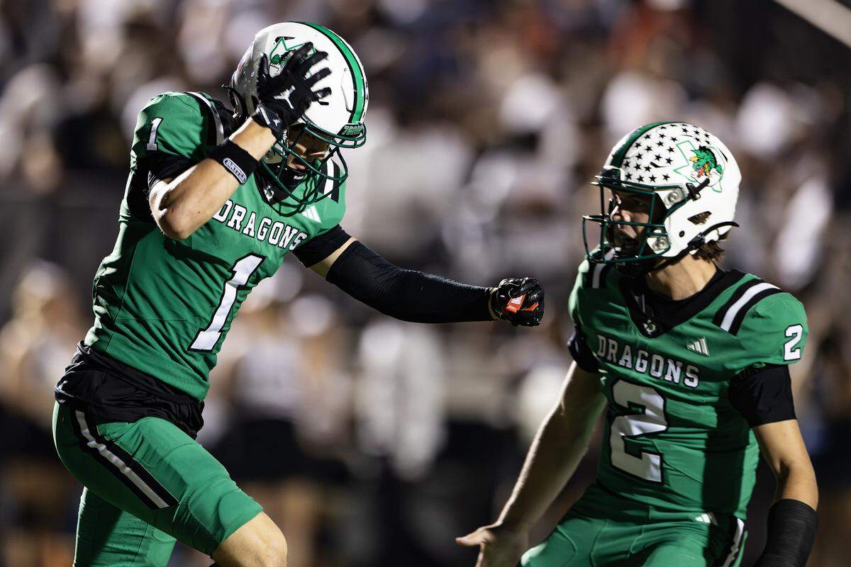 Southlake Carroll wide receiver Brock Boyd (1) celebrates with quarterback Angelo Renda (2) after scoring a touchdown in the second half of a high school game between Southlake Carroll and Euless-Trinity at Dragon Stadium in Southlake on Friday, Sept. 19, 2025.