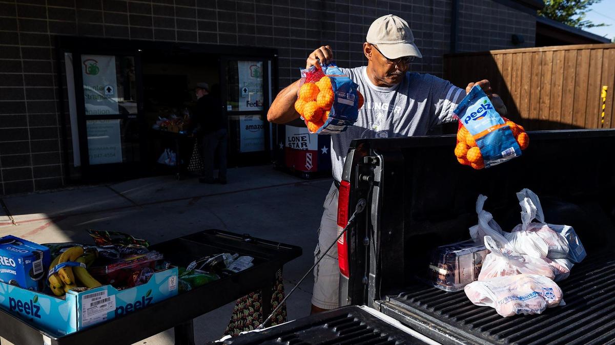 Michael Lloyd, a volunteer with Community Link for three years, loads groceries from the food pantry into a clients vehicle on Tuesday, July 22, 2025. The pantry provides about two weeks of food per pickup.