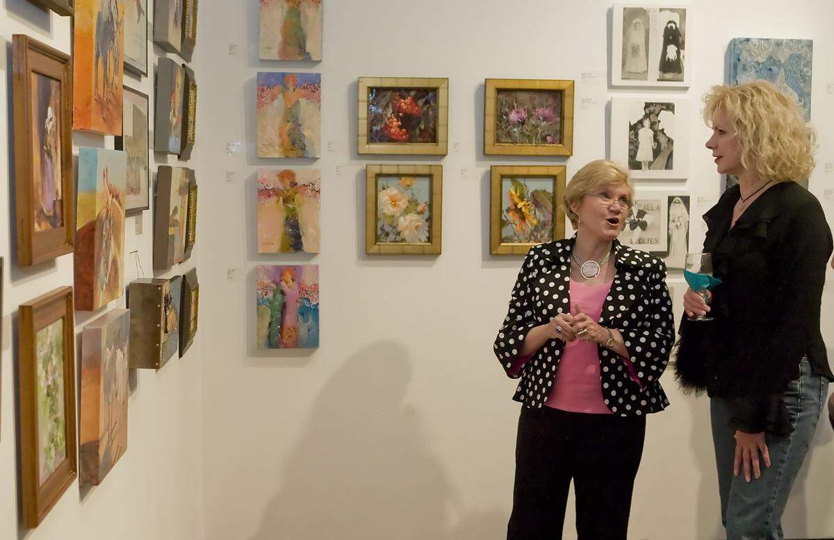 In September 2009, Lucy Brants, left, and Milinda Hall discuss artists' work during "Reception with the Artists" at the Fort Worth Community Arts Center