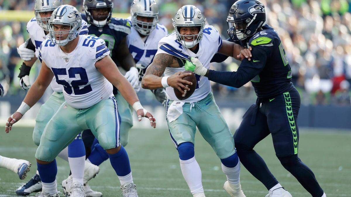 Dallas Cowboys quarterback Dak Prescott (4) is sacked by Seattle Seahawks defensive end Frank Clark, right, during the second half of an NFL football game, Sunday, Sept. 23, 2018, in Seattle.