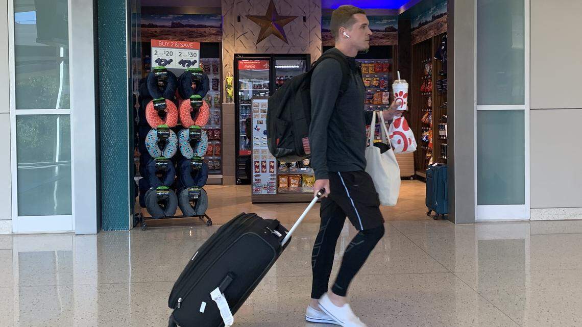 A traveler walks past Southwest News at DFW Airport’s Terminal E.