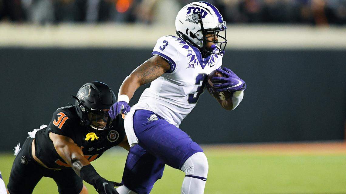 Oklahoma State safety Kolby Harvell-Peel (31) chases TCU running back Emari Demercado (3) during an NCAA college football game Saturday, Nov. 13, 2021, in Stillwater, Okla. (AP Photo/Brody Schmidt)