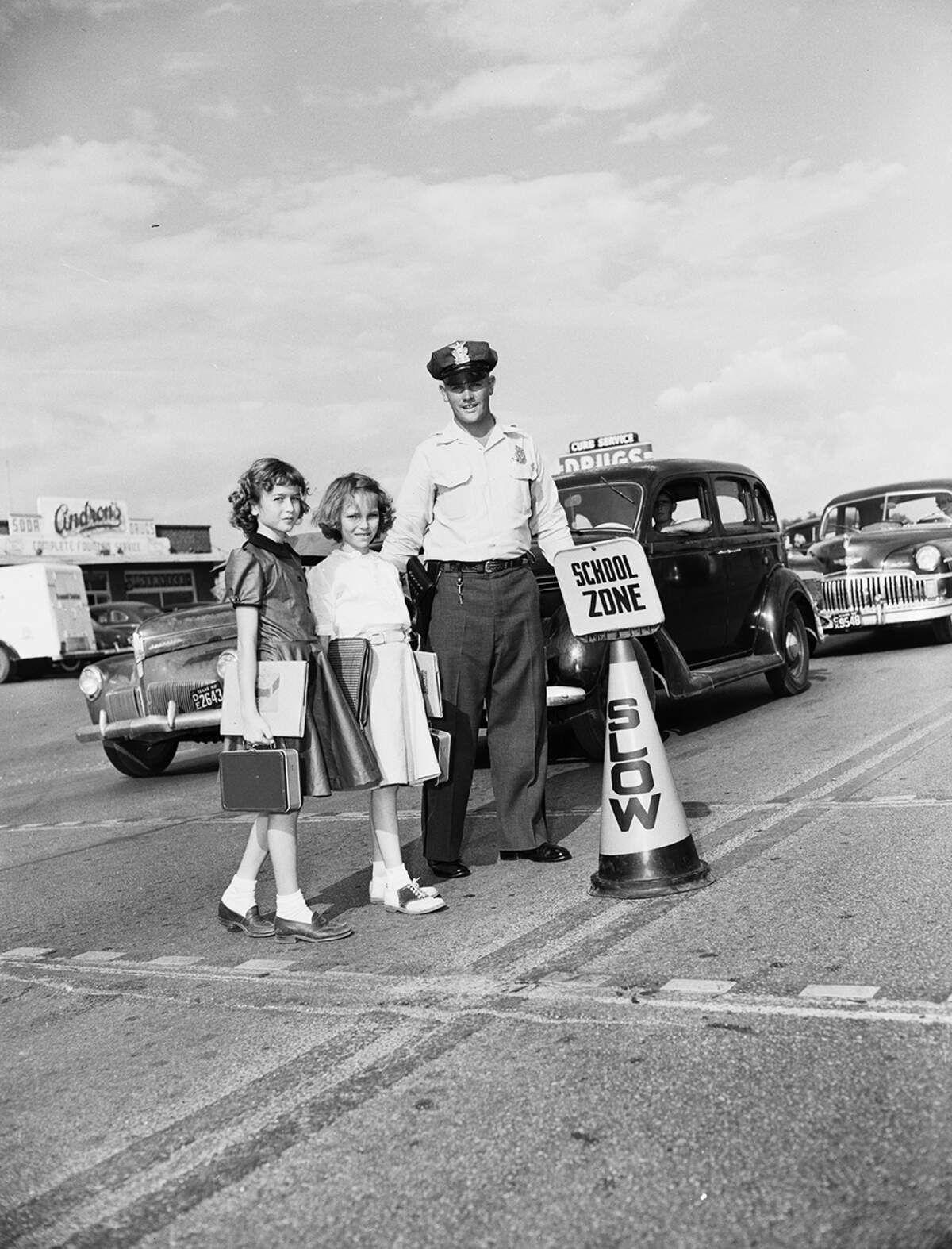 Sept. 15, 1952: “Motorists beware — a new type of school zone sign was put into use this week at schools located on or near some of the major traffic arteries. Here, two Springdale School fourth-graders, Janie Martin, 3817 Kimbo Road, and Sheila Ann William, 3821 Kimbo Road, are escorted across N.E. 28th Street by Motor Officer Milton Ellis.
