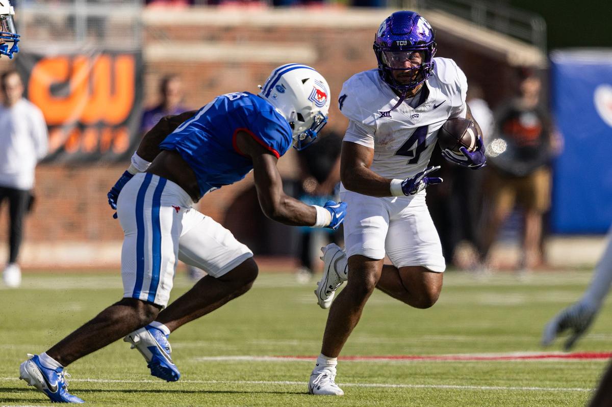 TCU running back Cam Cook (4) runs the ball against the SMU defense in the first quarter of a non-conference game between TCU and SMU at Gerald J. Ford Stadium in Dallas on Saturday.