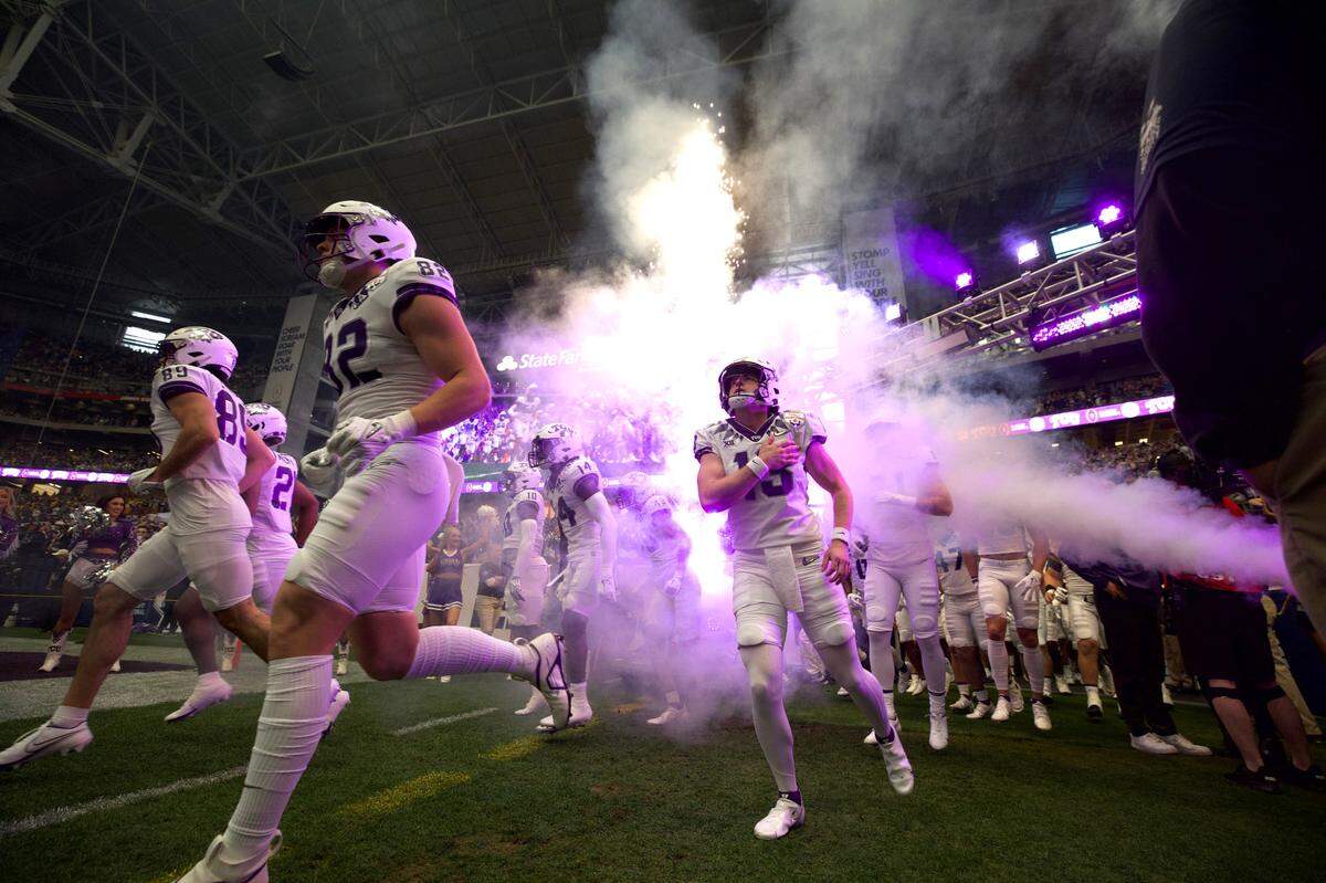 TCU quarterback Max Duggan and his team run onto the field before their game against Michigan at the Vrbo Fiesta Bowl in Glendale, Ariz., on Saturday, December 31, 2022.
