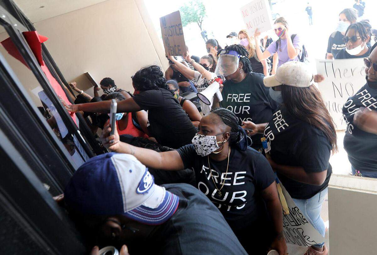 Members of Enough is Enough and family members gather at the Tarrant County Juvenile Detention Center on Friday, June 26, 2020, to protest the detainment of multiple youth accused of involvement in a park shooting on Mother's Day.