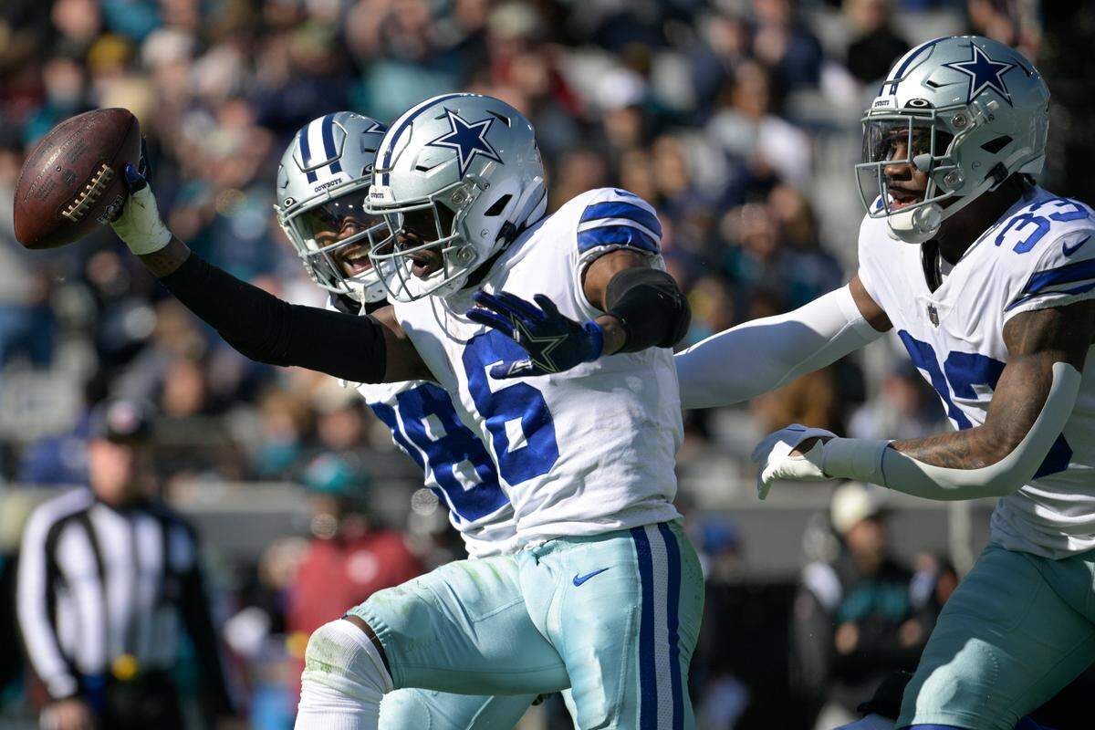 Dallas Cowboys safety Donovan Wilson (6) celebrates a fumble recovery with Ezekiel Elliott (21) and Damone Clark (33) during the first half of an NFL football game against Jacksonville Jaguars, Sunday, Dec. 18, 2022, in Jacksonville, Fla. (AP Photo/Phelan M. Ebenhack)