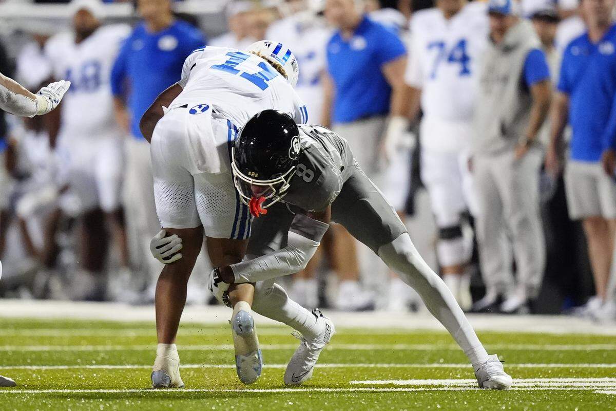 Sep 27, 2025; Boulder, Colorado, USA; Colorado Buffaloes cornerback DJ McKinney (8) tackles Brigham Young Cougars wide receiver Parker Kingston (11) in the fourth quarter at Folsom Field. Mandatory Credit: Ron Chenoy-Imagn Images