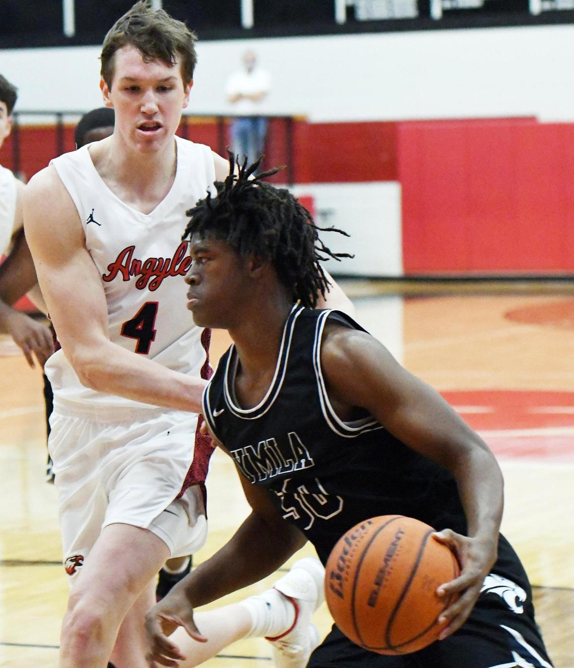 Argyle’s Nate Atwood, left, tries to defend as Young Men’s Learning Academy’s Monterrio Golightly drives to the basket during the first period of their 4A Region I Quarterfinal playoff game Saturday, February 27, 2021 at Colleyville Heritage High School in Colleyville, Texas. Argyle went on to win 49-40. Special/Bob Haynes
