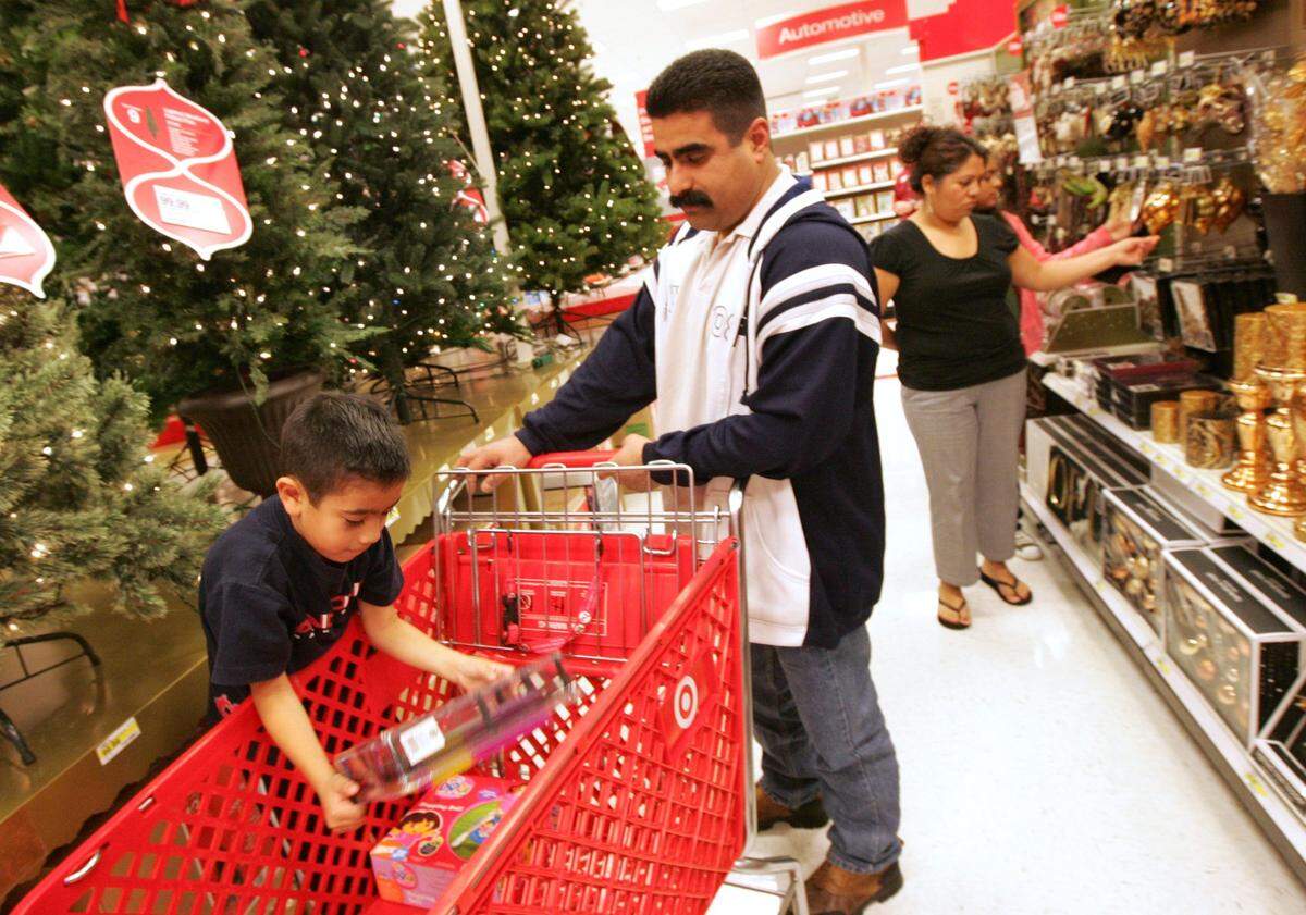 Nov. 25, 2008: Jose Arroyo Jr. helps his father, Jose Arroyo, shop at Target for Christmas decorations
