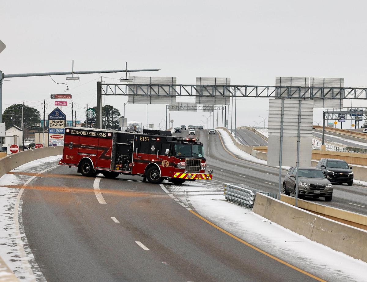 Ramps and highway entrances like this one in Bedford were blocked by emergency vehicles to allow crews to sand and de-ice ramps and bridges.