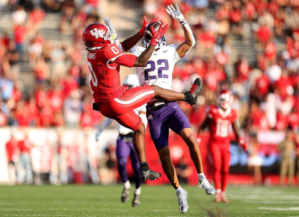 HOUSTON, TEXAS - NOVEMBER 22: Amare Thomas #0 of the Houston Cougars attempts to make a catch against Jordan Lester #22 of the Texas Christian University Horned Frogs in the first quarter of the game at TDECU Stadium on November 22, 2025 in Houston, Texas. (Photo by Kenneth Richmond/Getty Images)