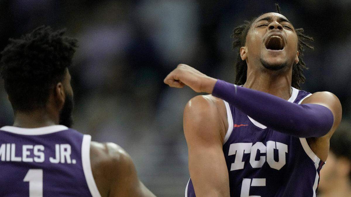 TCU forward Chuck O’Bannon Jr. (5) celebrates with guard Mike Miles Jr. (1) during the Horned Frogs’ win over Kansas State on Friday.