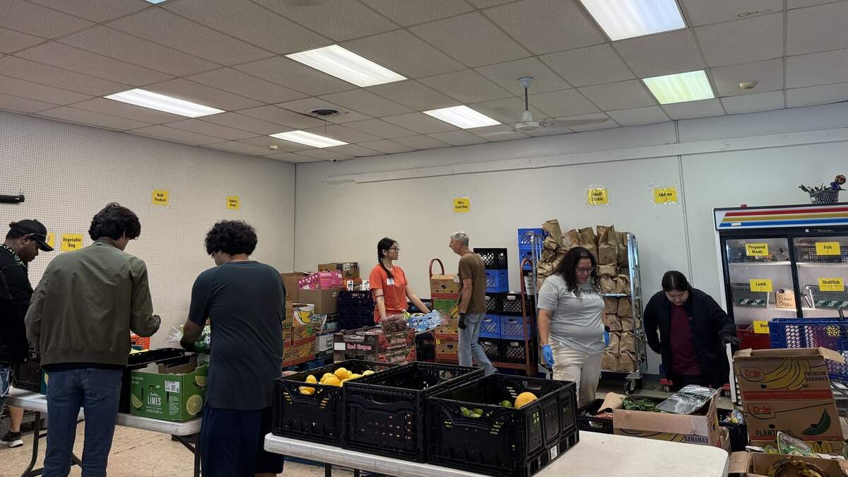 Volunteers at Arlington Charities gather and pack fruit, produce and pantry items for neighbors in need in Tarrant County.