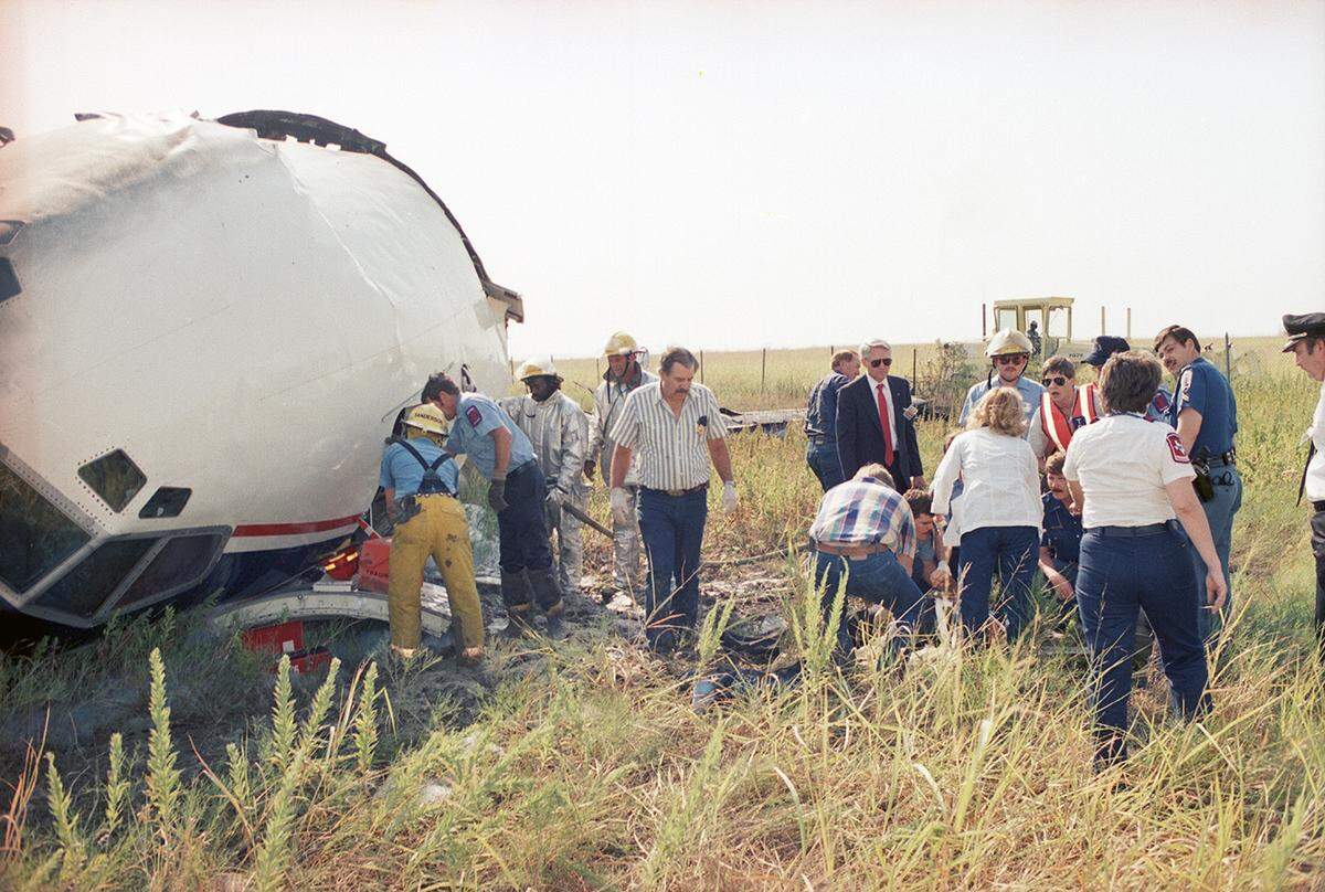 Aug. 31, 1988: Emergency workers tend to an injured person, possibly a crew member, who was pulled from the wreckage of Delta Flight 1141 after it crashed during takeoff at Dallas-Fort Worth International Airport.