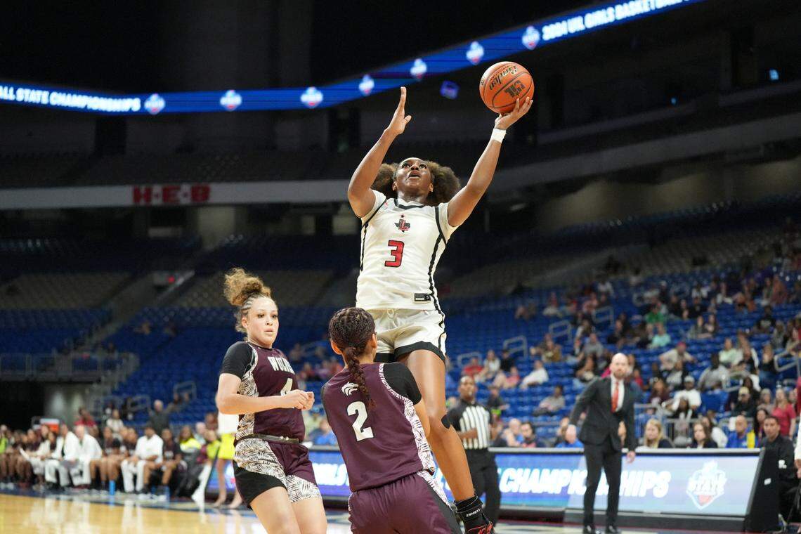 Frisco Liberty’s Jacy Abii, the Championship Game MVP, goes high over Mansfield Timberview’s Dani Milliner in the Class 5A state championship game on Saturday, March 2, 2024 at the Alamodome in San Antonio, Texas. Liberty defeated Timberview 60-51.